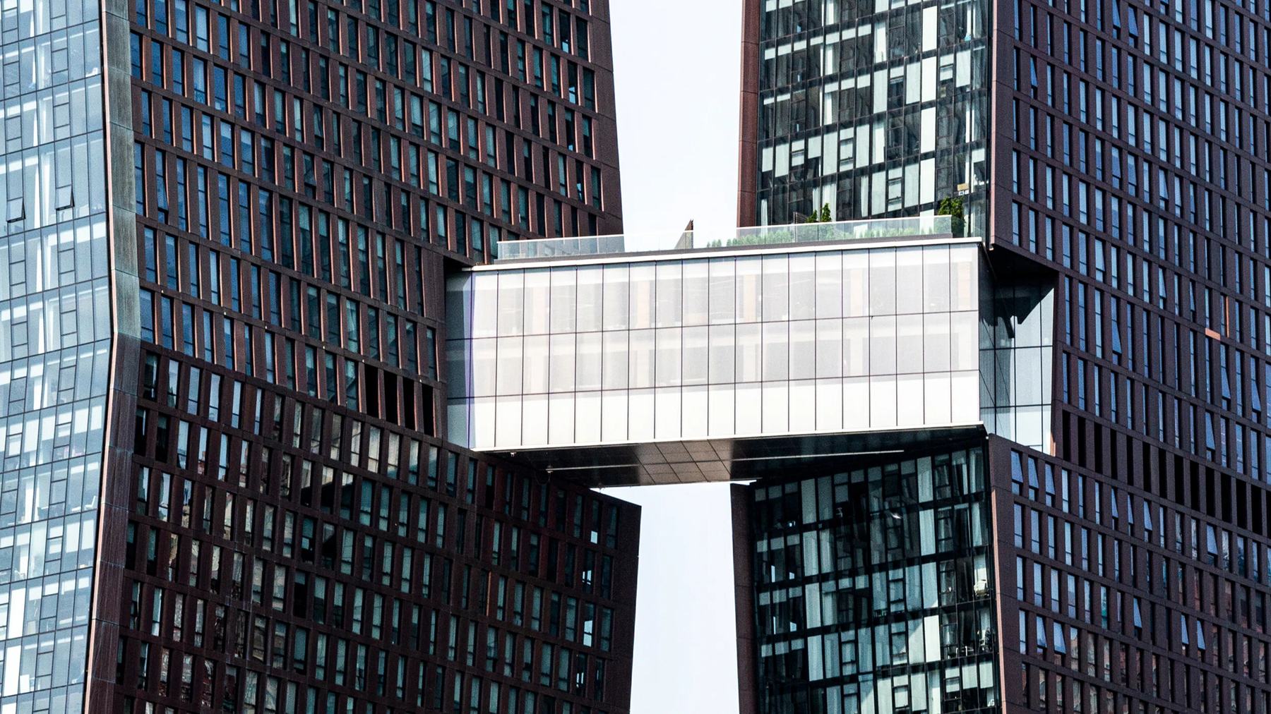 The three story skybridge spans the gap between the two towers high above the street.